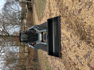 Deere 333P with bucket attachment
